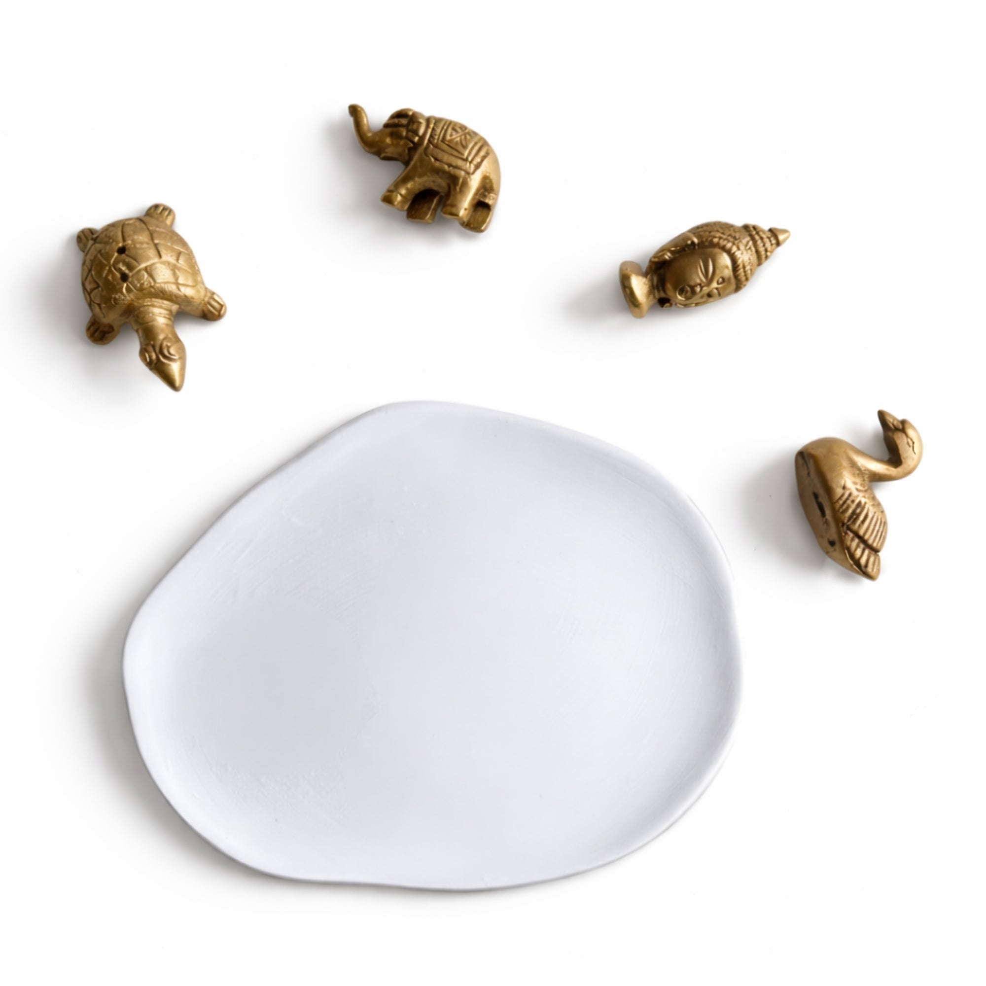 White ash catcher tray on a white background with small brass animal figurines incense holder.