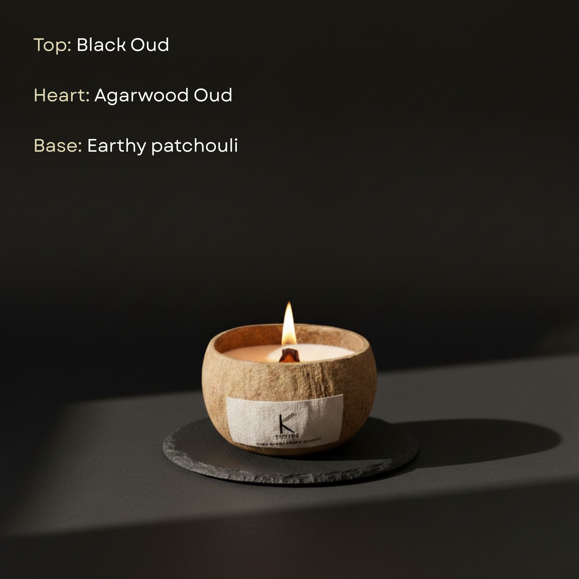 Natural Candle in a coconut shell with a label on a dark background, featuring notes of Black Oud, Agarwood Oud, and Earthy Patchouli.