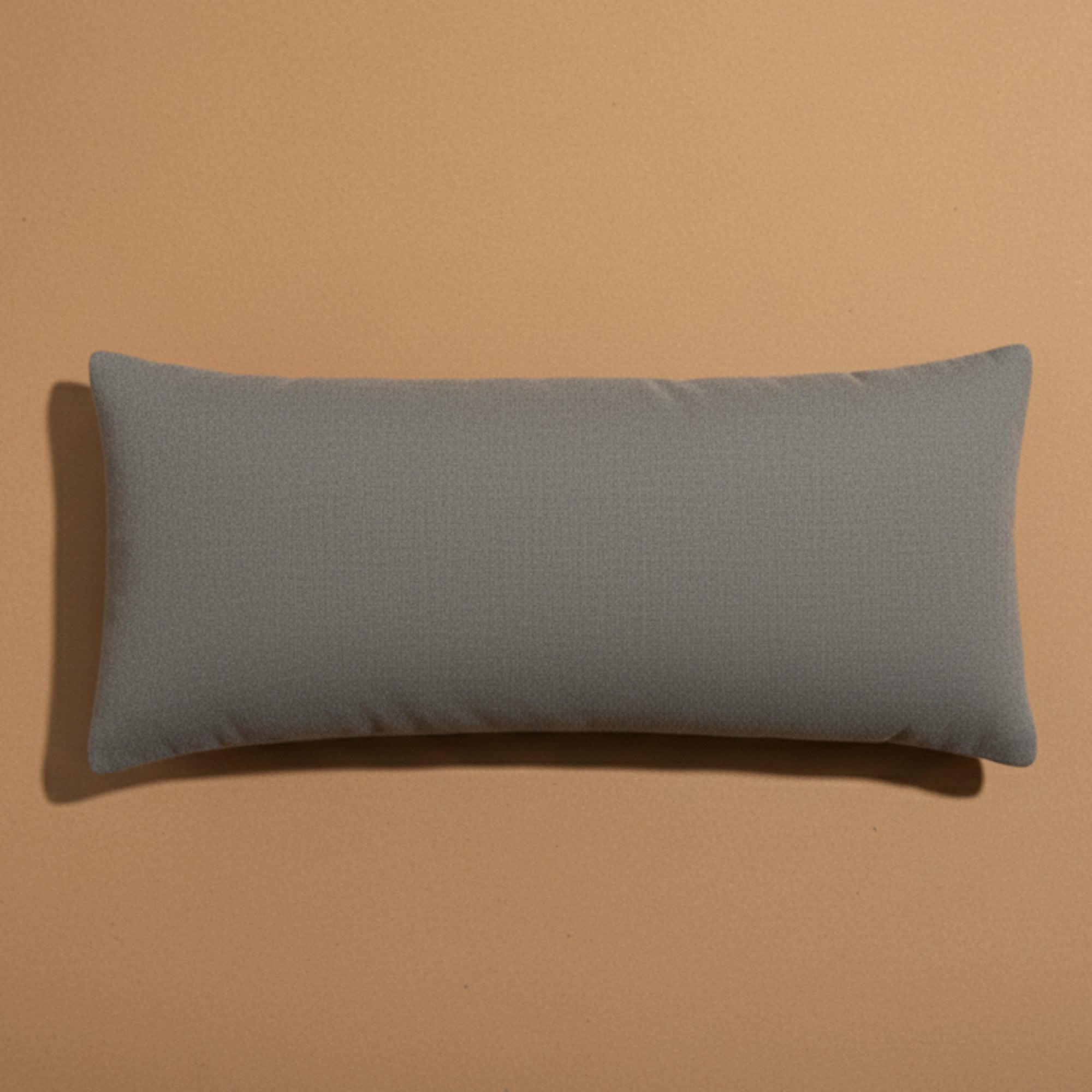 Gray yoga and meditation eye pillow on a beige background