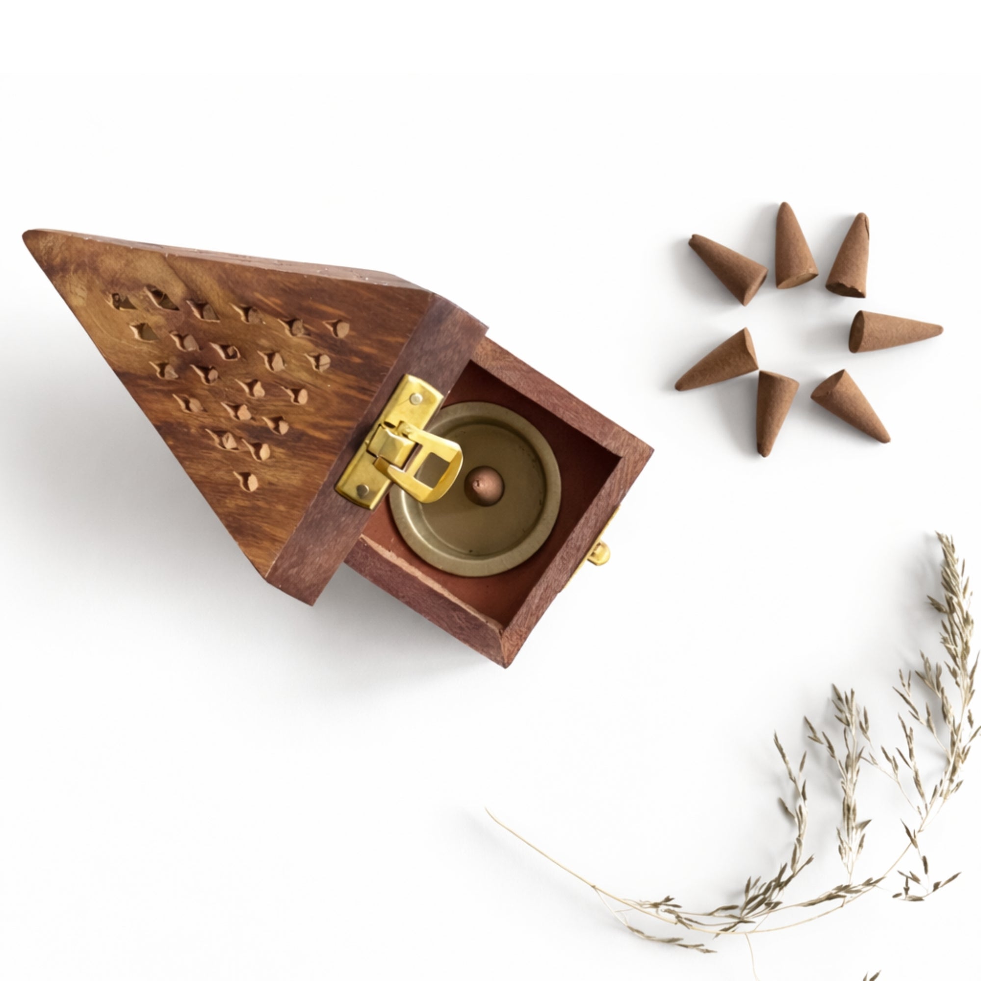 Wooden incense burner with gold accents and cones on a white background