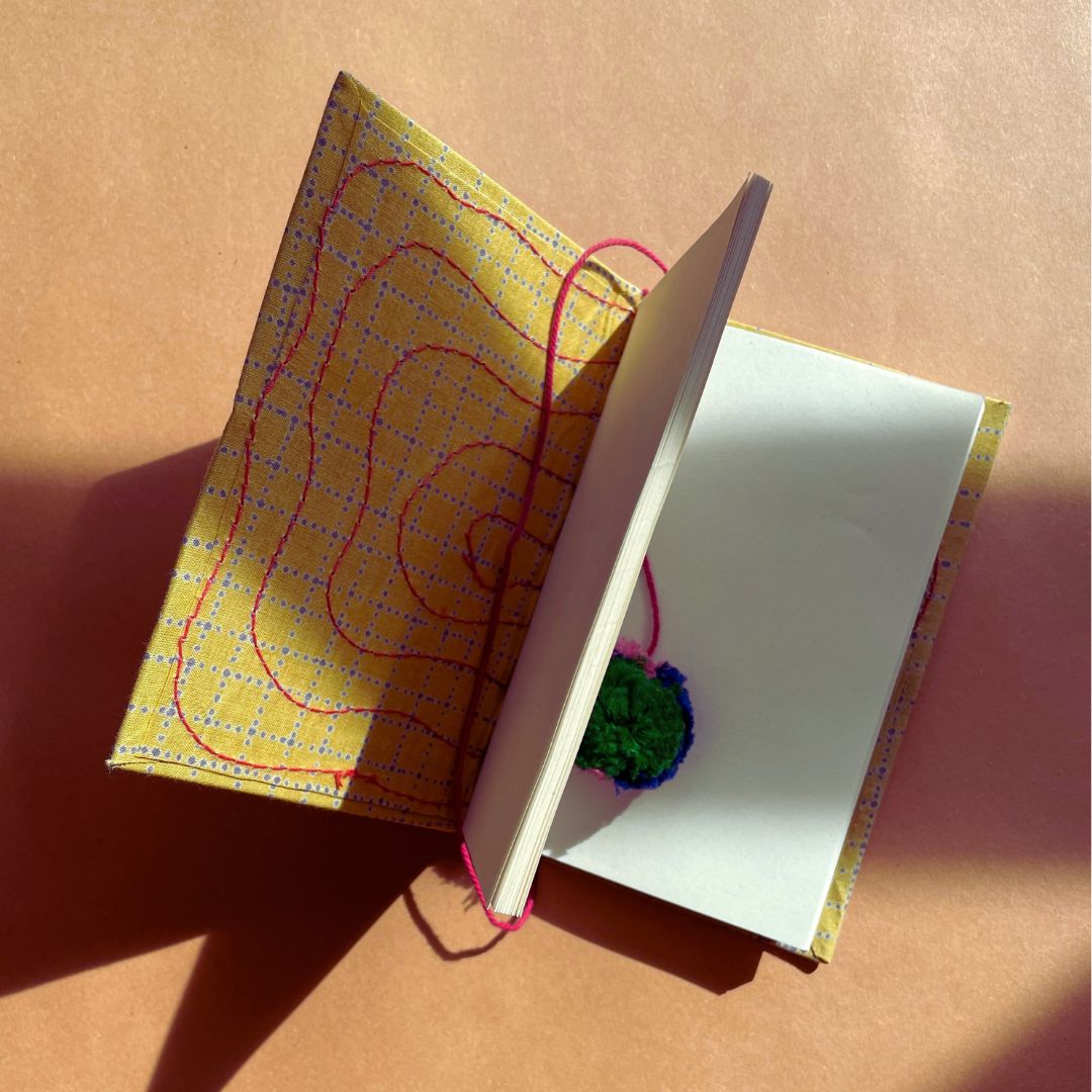 Handmade travel yoga journal with pom-pom detail