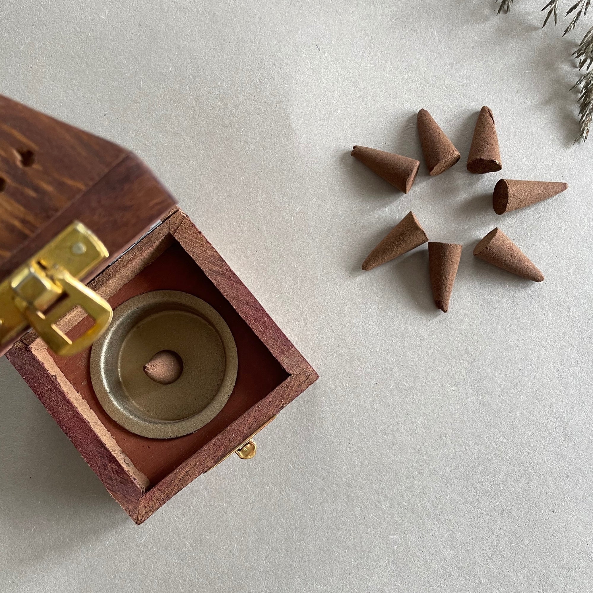 Natural wood triangle ash catcher for incense cones.