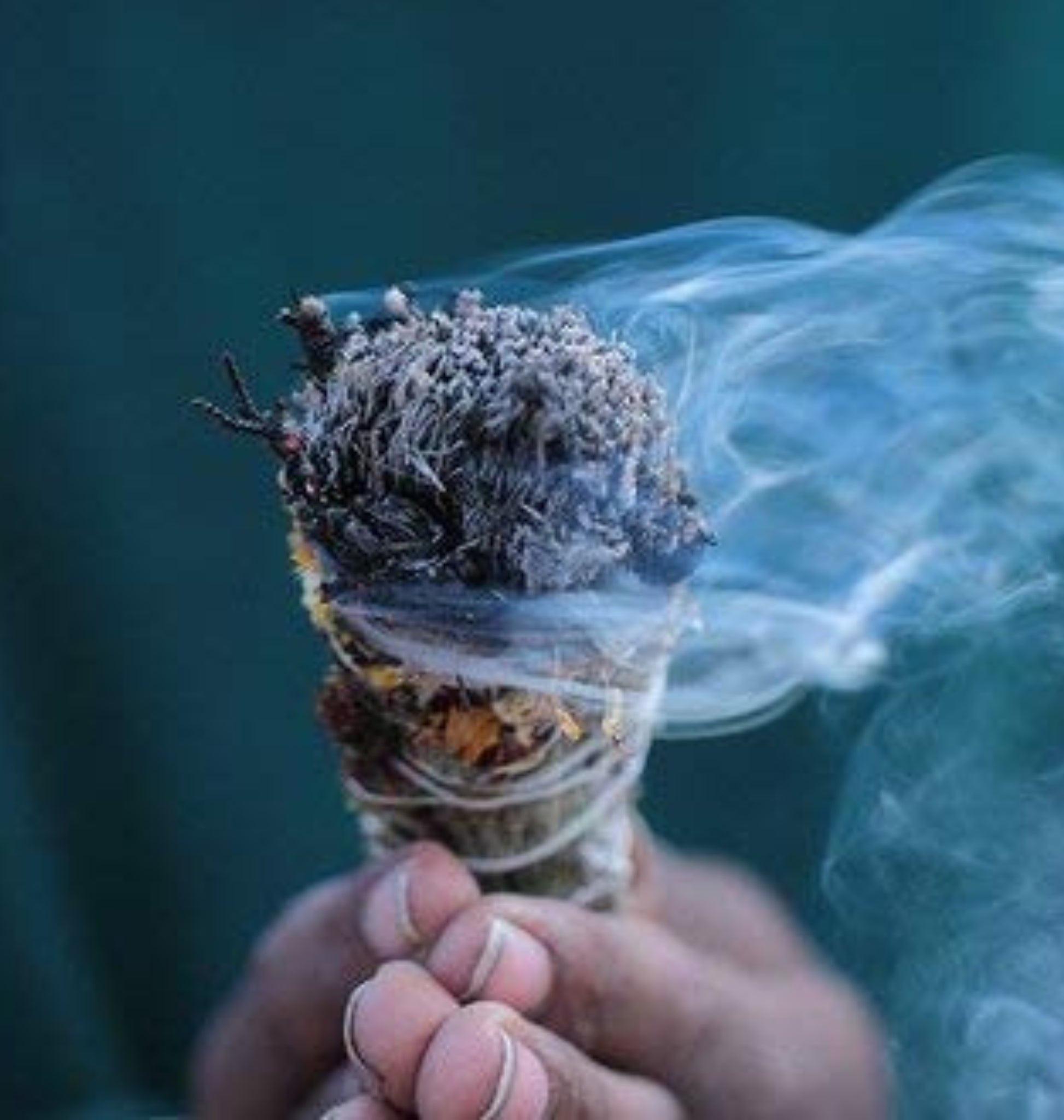 Eucalyptus smudge stick is being lit for  ritual