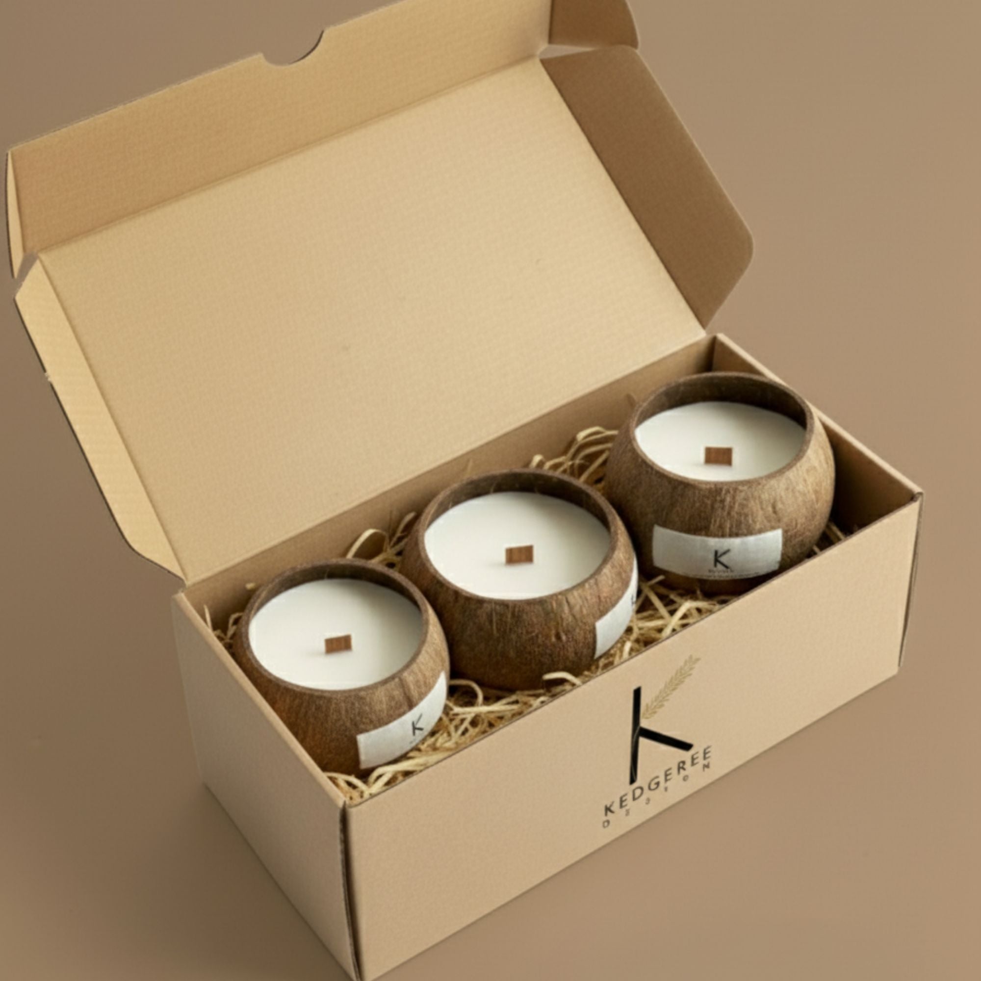 Three coconut-shell natural plant wax hand poured candles in a eco luxury gift box with Kedgeree branding.