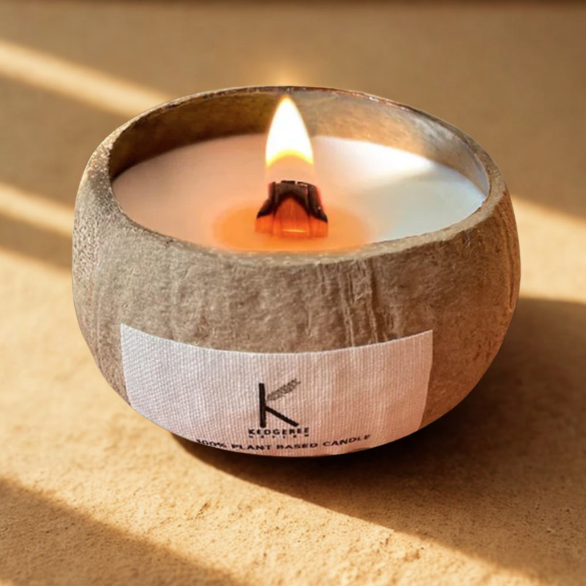 Plant-based Coconut Shell Candle in a coconut shell with a label on a beige background