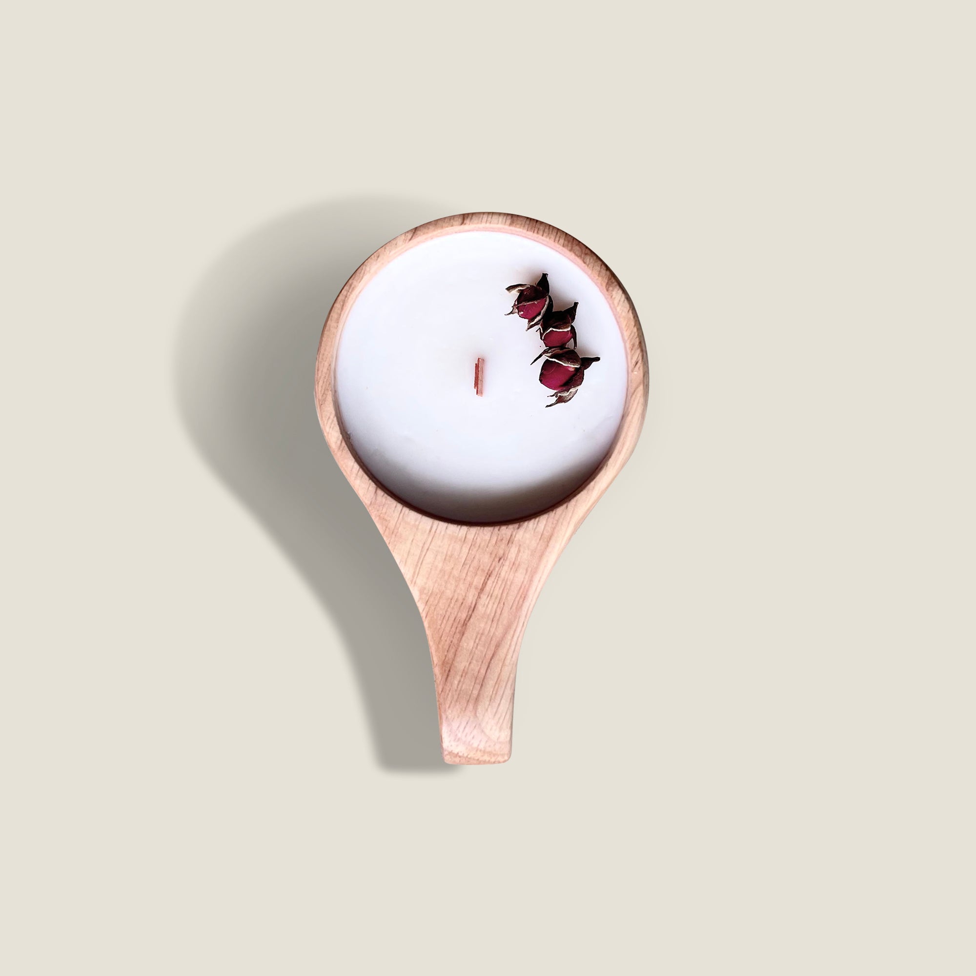 Jaipur Rose oak wood candle with a burning wick, hand-poured with plant wax and essential oils. The candle has a sweet and floral scent, a sleek and modern design, and comes in a oak wood jar with a wooden lid.