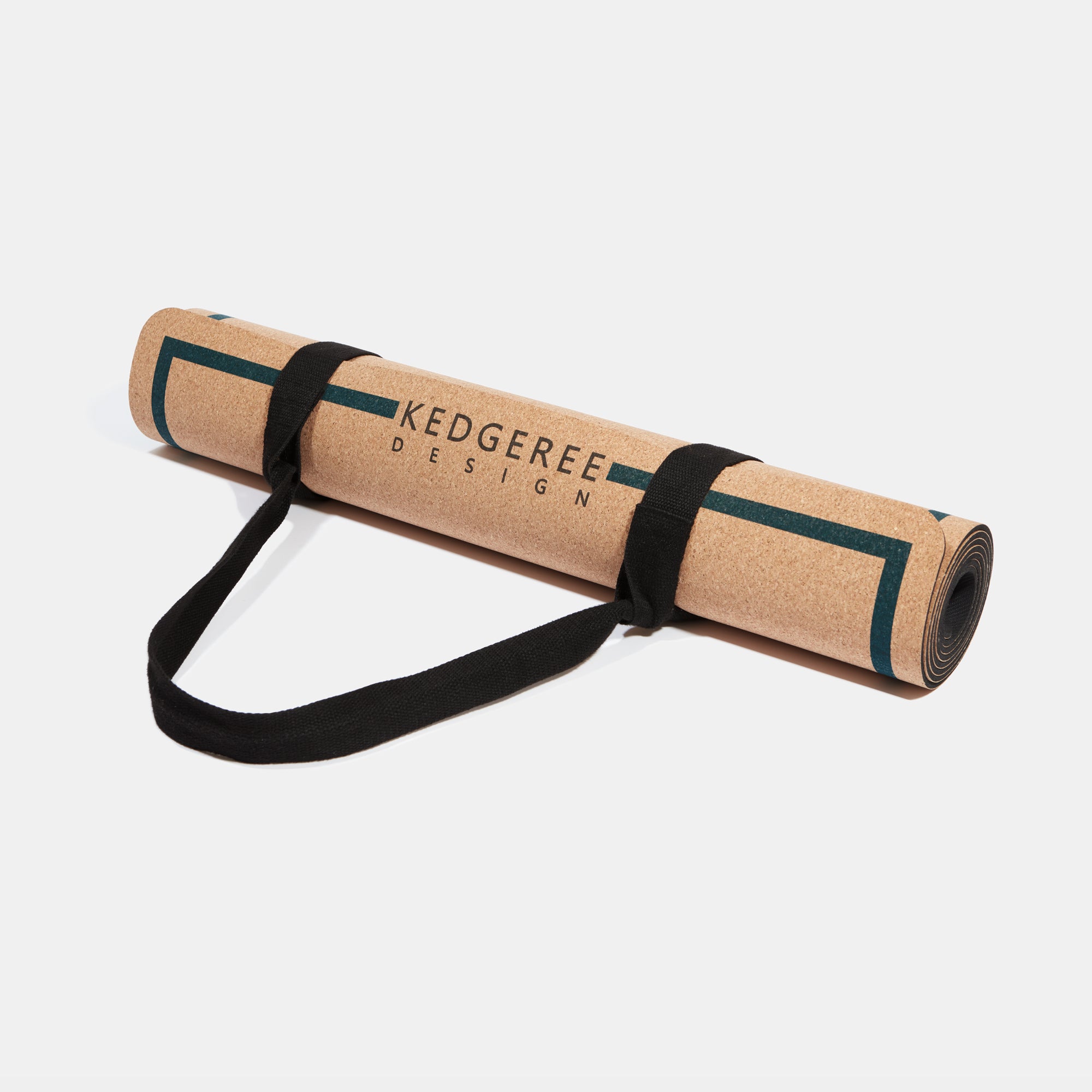 Cork yoga mat rolled up and secured with strap.