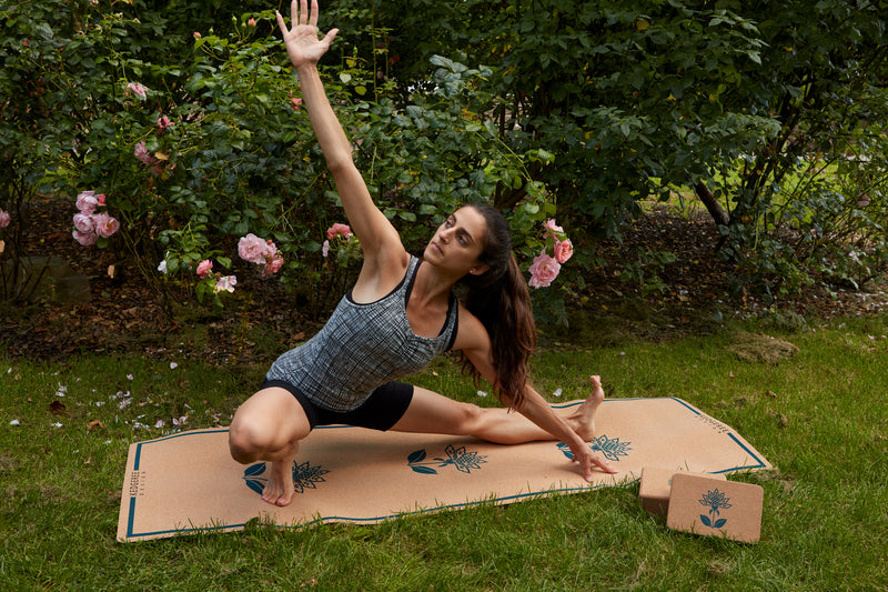 Person using cork yoga mat in yoga pose.