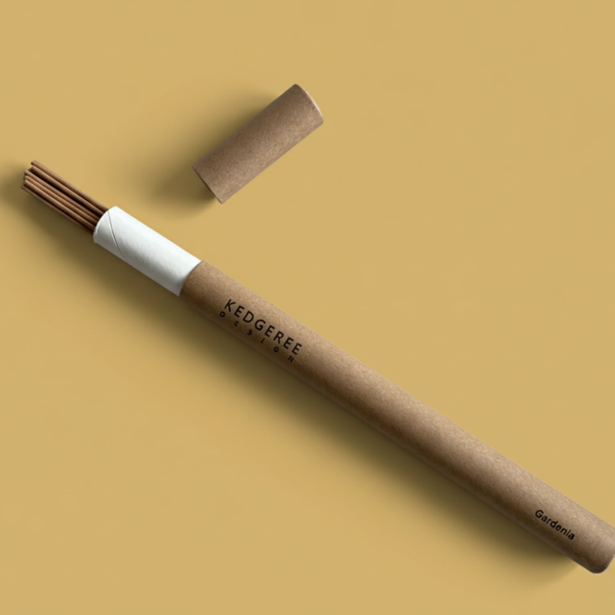 Kedgeree hand-rolled natural incense tube placed against a brown backdrop 