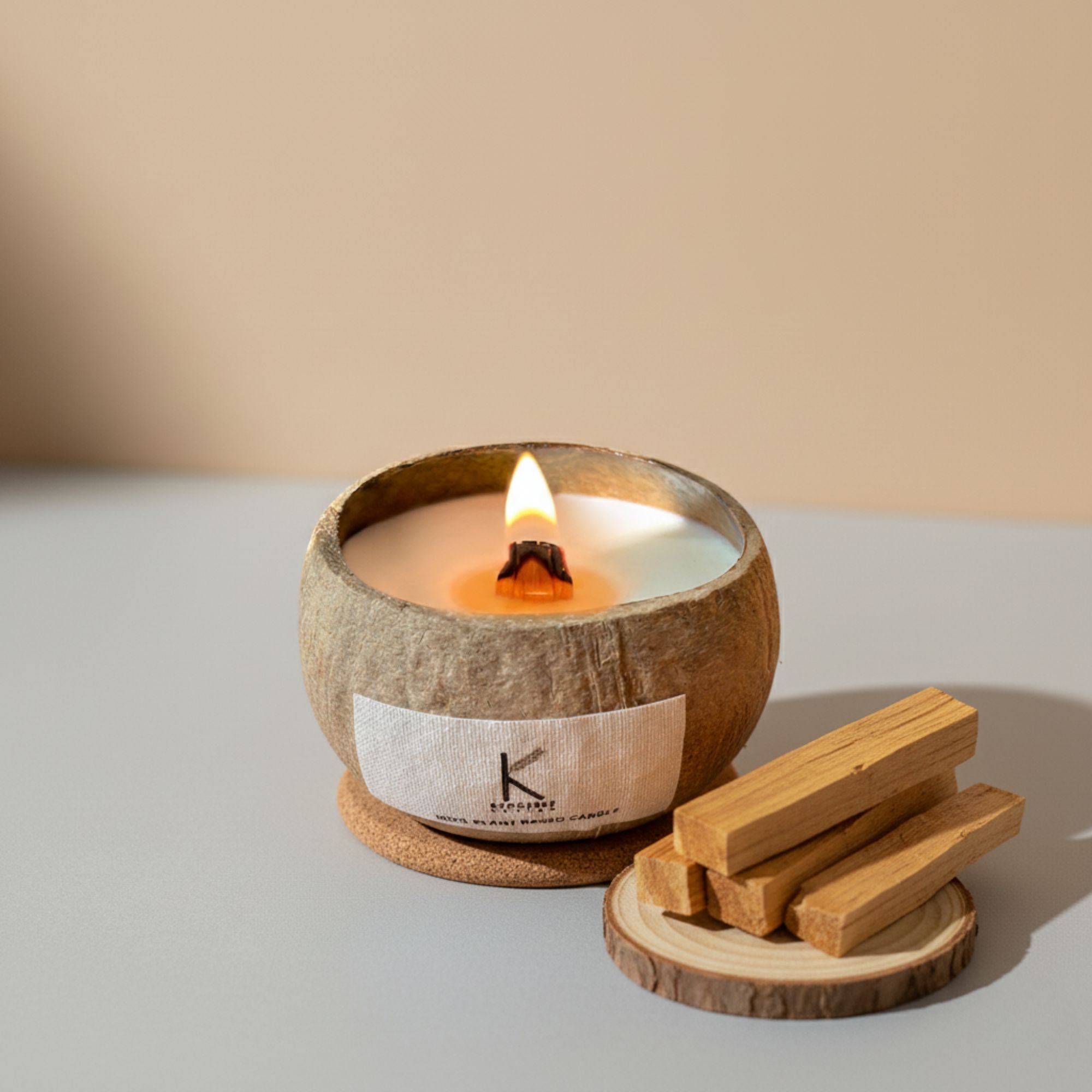Plant based Candle in a coconut shell with wooden wicks on a neutral background 
