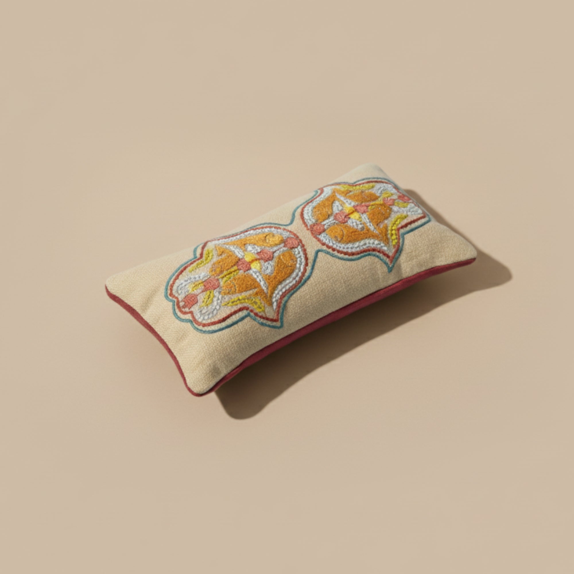 Hand Embroidered beige eye pillow with floral embroidery filled with lavender seeds on a beige background