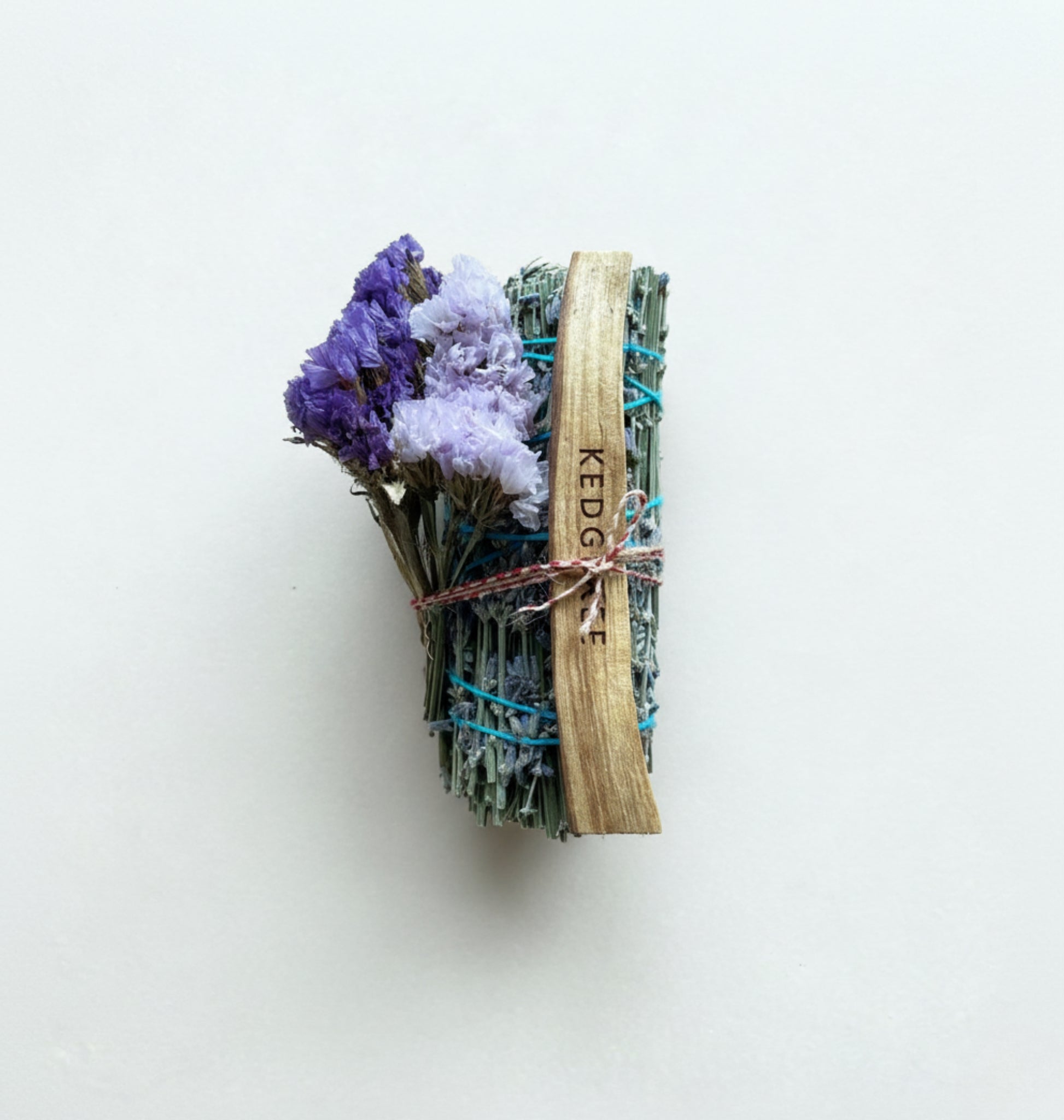 Handmade lavender smudge stick with AA-grade Palo Santo and pouch, gently smouldering for a calming home ritual.