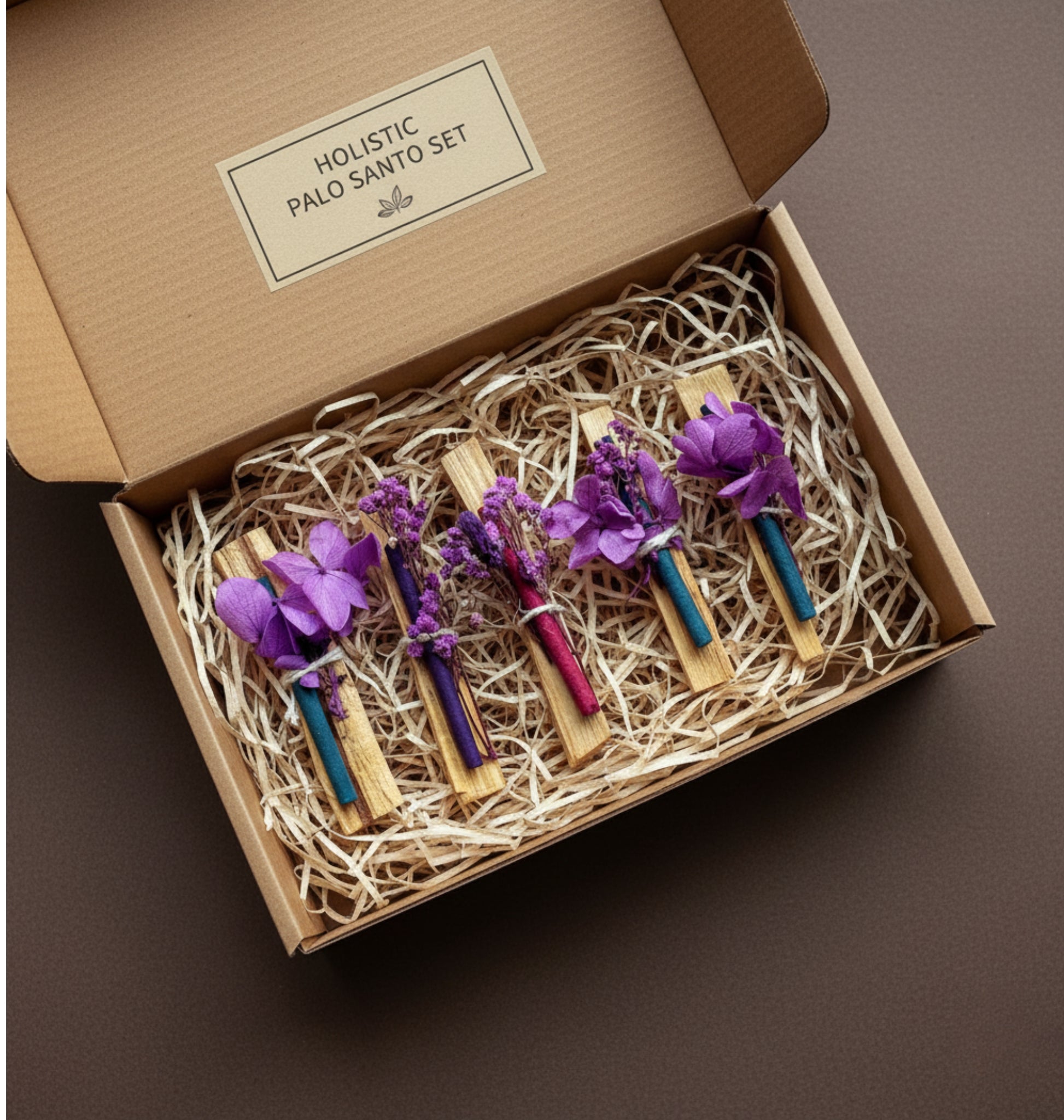 Holistic Palo Santo set in a cardboard gift box with purple flowers on a brown background