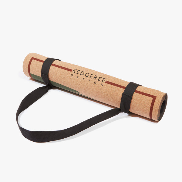 Rolled up cork yoga mat with strap