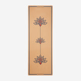 The travel cork yoga mat with beautiful lotus design in it