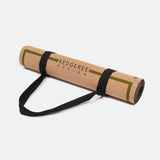 Cork yoga mat rolled up and secured with strap.