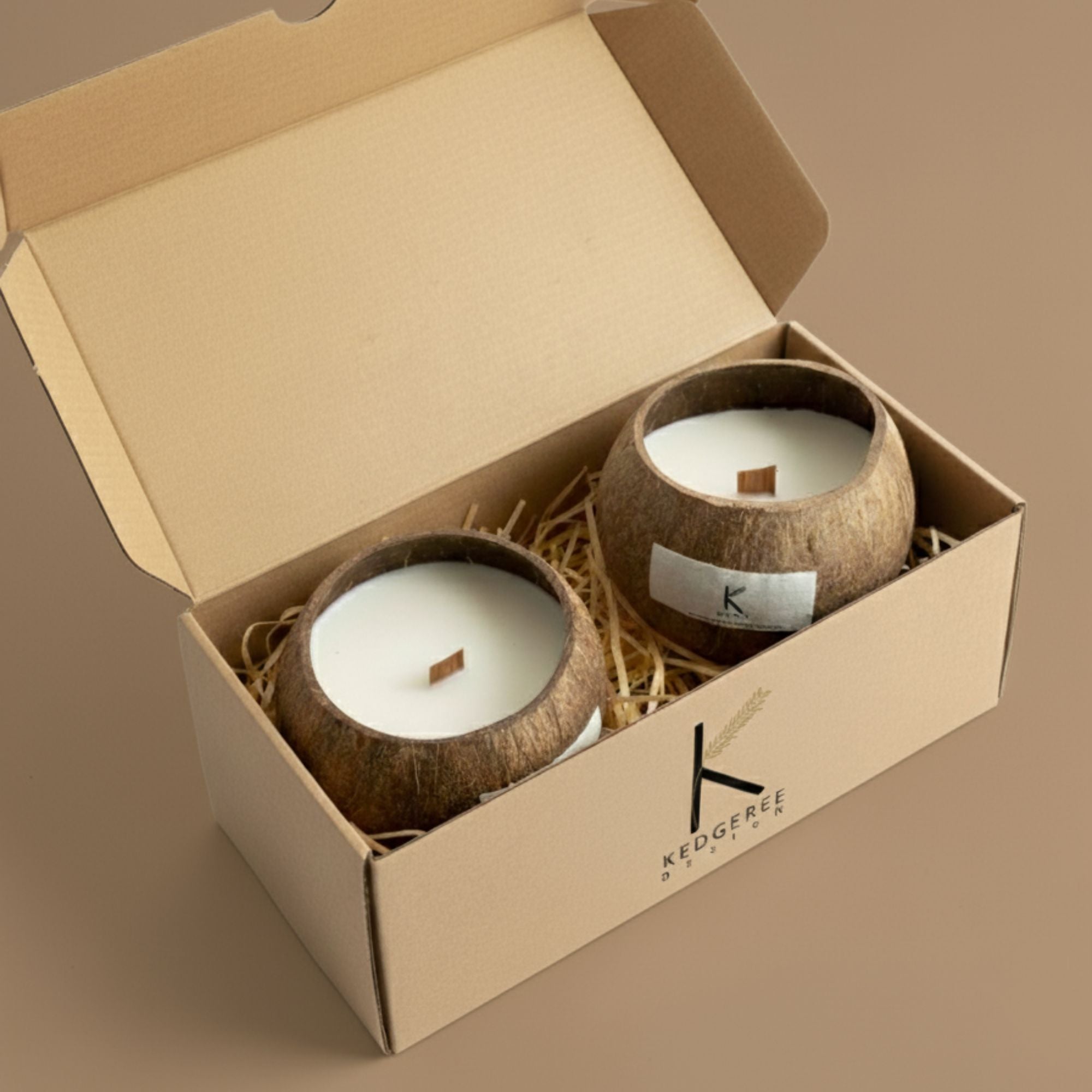 Two plant-based  eco friendlycoconut candles in a cardboard gift box on a brown background
