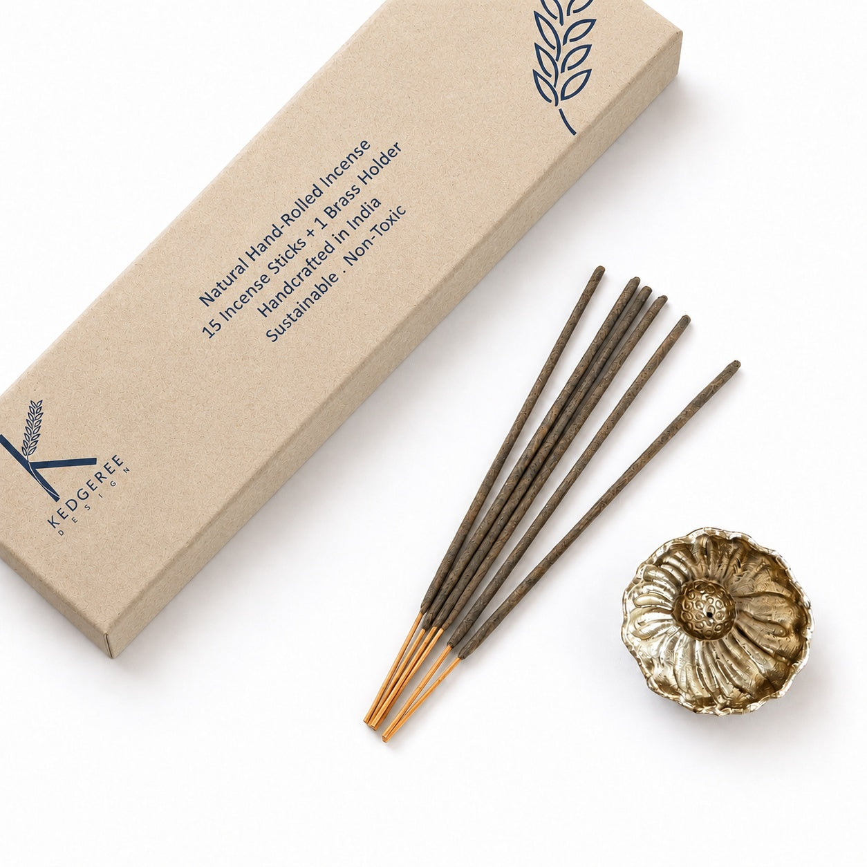 A set of premium oudh incense sticks with a brass.  flower-shaped holder and a kraft paper box, photographed on a clean white background.
